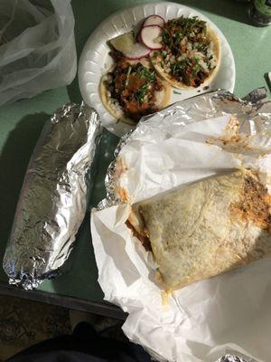 Huge burrito and quesadilla, tacos in back