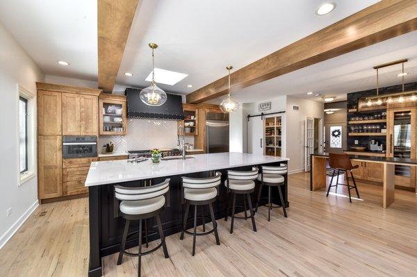 This stunning open-concept kitchen features modern + natural lighting, along with sleek appliances and custom cabinetry.