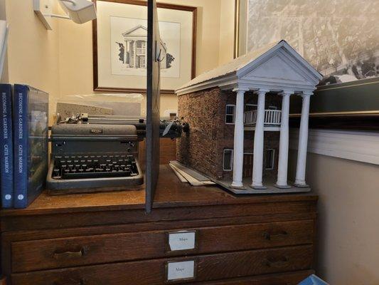 A model and antique typewriter inside Landmark Booksellers