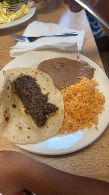 Kids barbacoa taco and rice and beans.