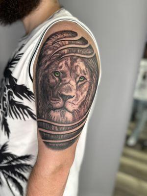 Lion portrait tattoo upper arm