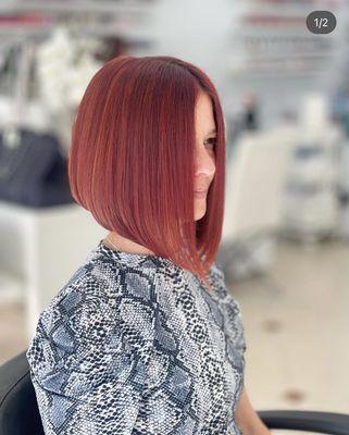 Unleash your inner boldness with this vibrant red short hair color and bob haircut, radiating confidence and showcasing a modern twist.