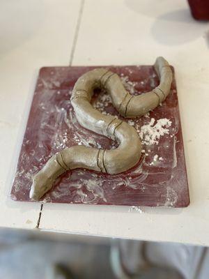 My attempt at a sea snake in the Sculpture class. Can't wait for the glaze.