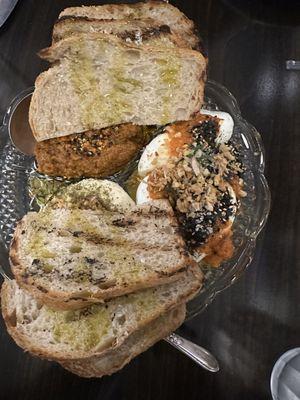 Farmers cheese with za'atar, garlic, honey, carrot muhammara, jammy eggs with harissa and furikake.