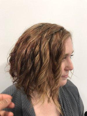 RO7 , 8nn , with blonde highlights complements her cascade curls.