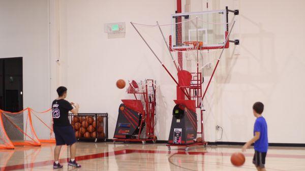 Practicing shooting baskets on the Shootaway Gun machine.