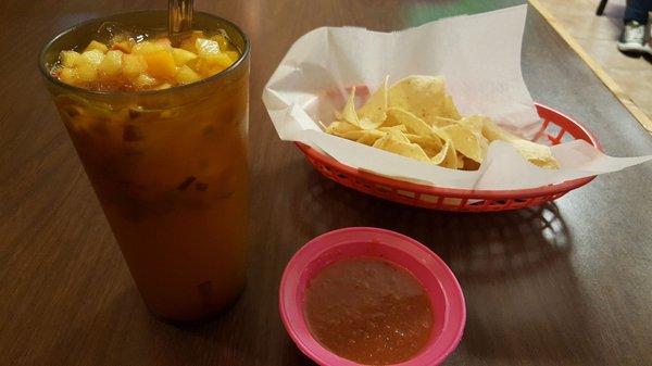 Complimentary chips and salsa with mixed fruit aqua fresca