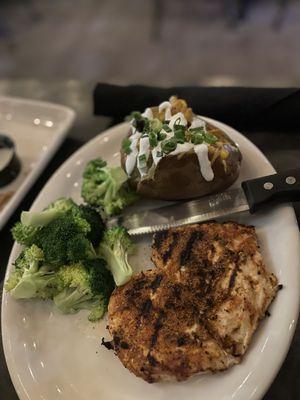 Grilled chicken blackened with backed potato and broccoli