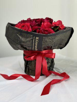 Stylish and elegant arrangement of scarlet roses in a box.