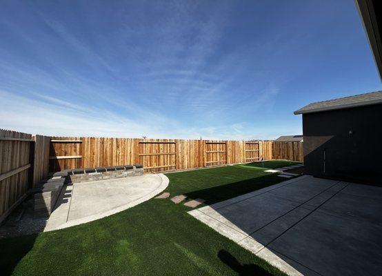 Before bench was finished, cement patio and seating area, turf