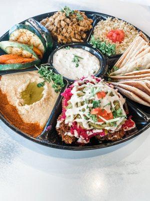 Pita Family Meal with chicken, falafel, seasoned rice, grilled veggies, traditional hummus, and pita bread.