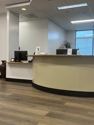 Front desk staff on the left gathered and not even facing patients