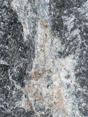 Closeup of a black granite boulder.