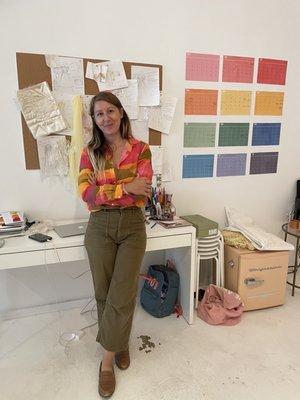 The shop owner, Christina, in front of her desk