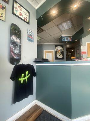 Reception area of shop with Vince's logo and shirt.