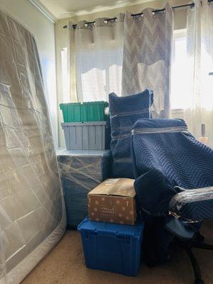 Boxes, mattress, chair, table and bins.