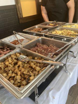 This is the beginning of the buffet with two kinds of eggs, two kinds of meat plus ham home fries