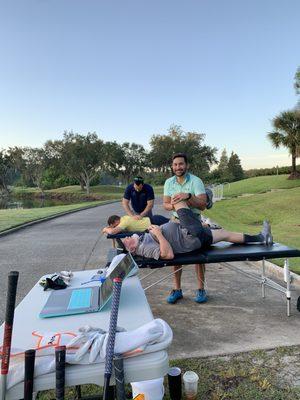 Dr. John Broussard, DO and Dr. Brian Broussard, DPT warming up golfers for a charity golf tournament at Westchase Golf Club