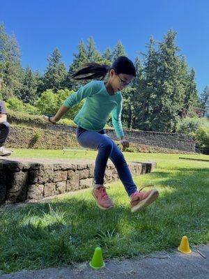 Student plays "Jump the River" with her parkour class at Mt. Tabor Park.