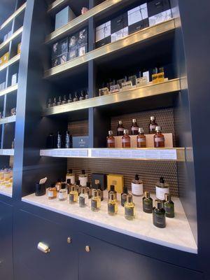 Fancy scents arrayed by brand/house, classy interiors and shelving.