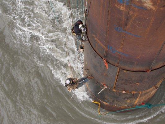 Rope access oil refinery at sea.