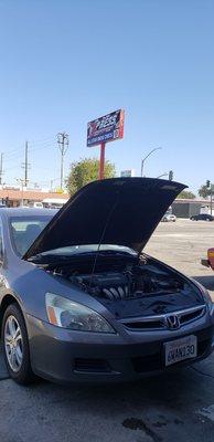 Car being serviced at All-Star Smog Check.