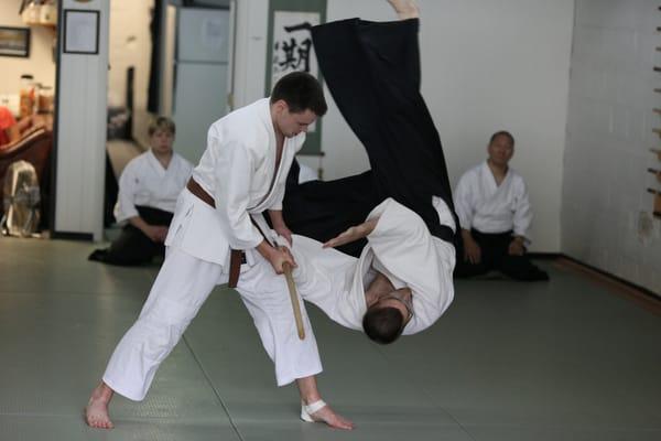 A candidate testing for his black belt demonstrates "bokken dori," or sword disarming techniques