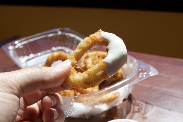 Onion ring dipped in blue cheese.