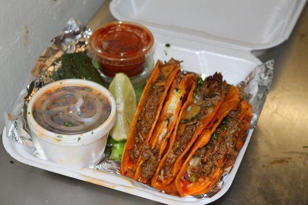 Our tacos dorados de birria. Paired with a side of consome, lemon and a grilled pepper