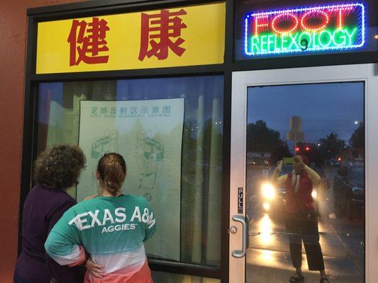 We regularly take friends visiting from out of town to the Health Spa. Here is Becky and Erica checking out the foot chart in the window.