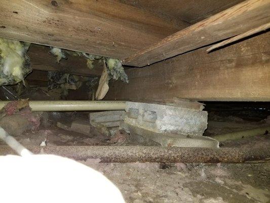 Failing supports in a crawlspace.