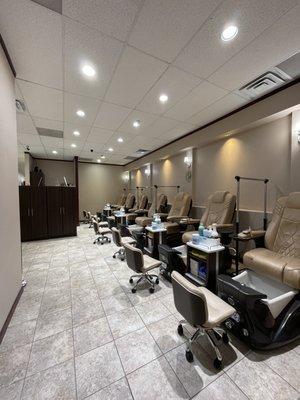 Pedicure room (7 chairs) with clear dividers inbetween the chairs.