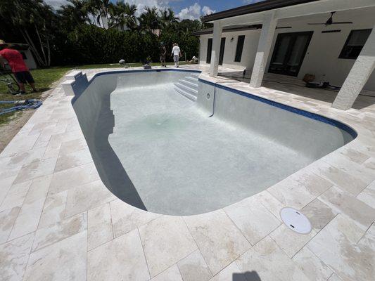 Atlantic cream French pattern infinite edge Travertine deck, SGM Diamond Brite and Tsunami tiles.