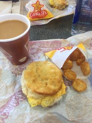 Breakfast. Egg and cheese biscuit, coffee, and hash rounds.