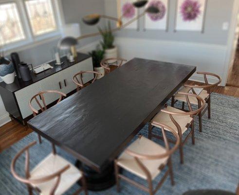 Farmhouse style solid slab table, stained and toned black creating a unique and customized look to match the clients desires.