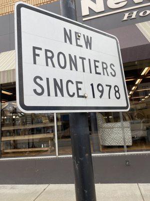 Street sign in front of store.