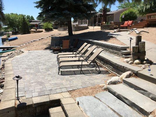 Paver patio  with retaining wall in the form of a bench adjacent patio