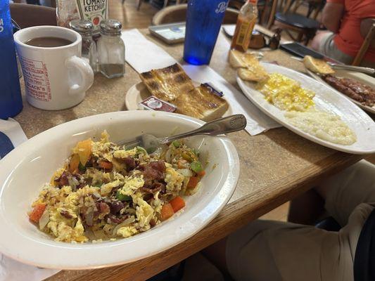 Breakfast bowl = yummy! 2 eggs over medium, cornbeef hash and grits  Toasted Cuban bread