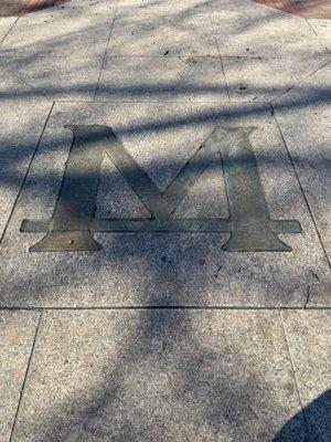 2023-03-23. The Bronze M at The Diag. Step on the M and you must run naked from the M to the pumas at Ruthven Museum at midnight.