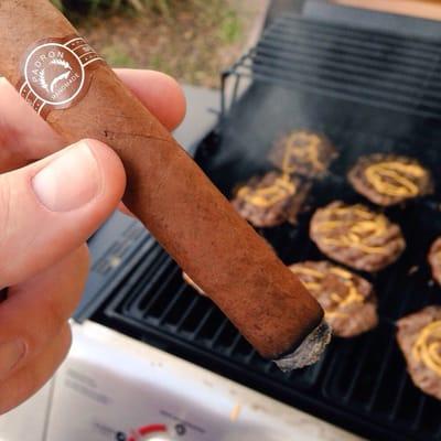 A Padron and burgers on the grill.