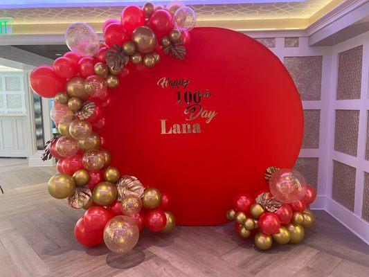 Circle Backdrop With A Cascading Arch In Red & Gold