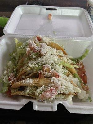 A plate of four fried tacos ground beef