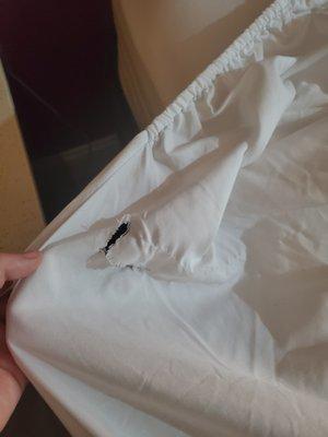 Torn fitted sheet, just one of the holes