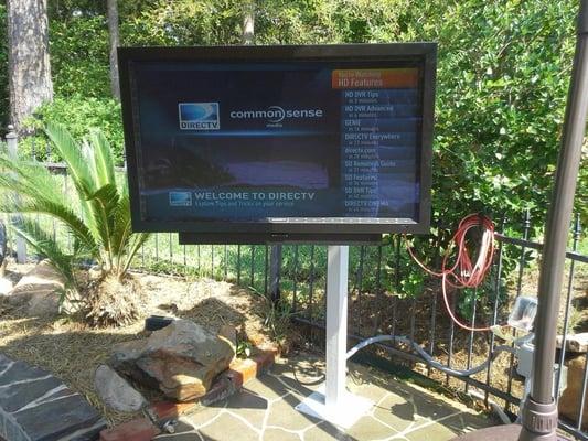 Outdoor tv next to pool.