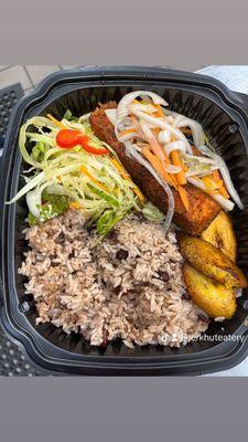 Escovi Salmon with rice and peas, cabbage, and plantains.