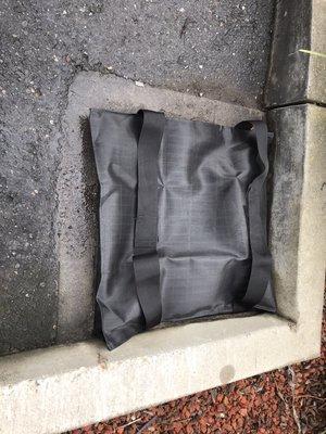 After Cleaning the Storm Drain, Protect the Drain with a Sediment Bag.