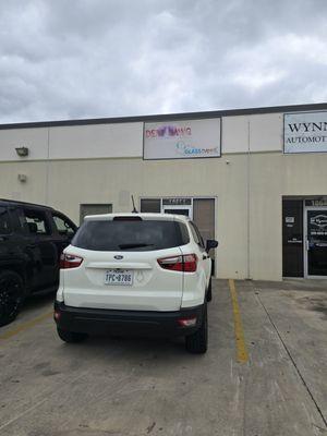 My hail damaged ecosport before dent dawg fixed it. In front of their store