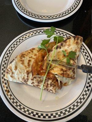 Meatball sandwich with parmigiana and hot peppers.