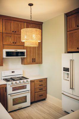 Waypoint Cabinets, green backsplash tiles and cafe appliances