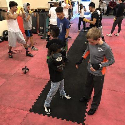 Youth Program students helping each other learn techniques!